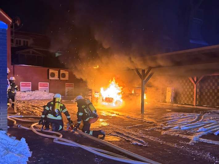 FW-AUR: Zeitgleich brennt PKW unter Holzcarport